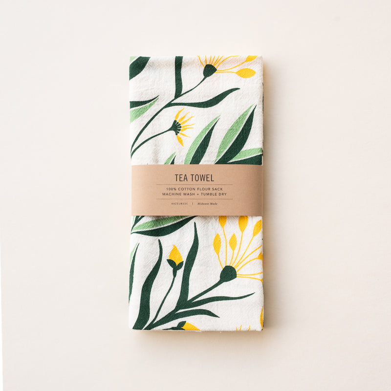 A single 100% cotton flour sack towel with an illustration of a bouquet of yellow flowers