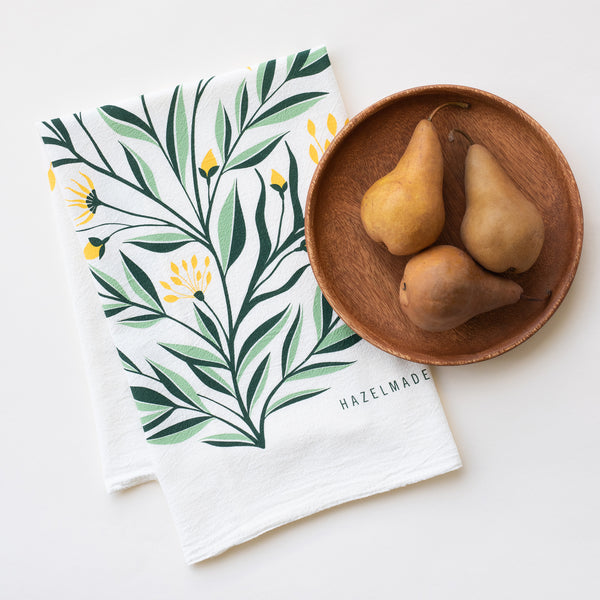 A single 100% cotton flour sack towel with an illustration of a bouquet of yellow flowers