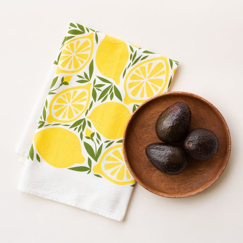 A single 100% cotton flour sack towel with an illustration of lemons