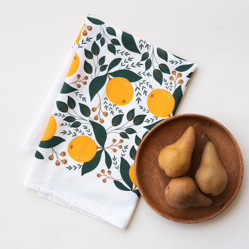 A single 100% cotton flour sack towel with an illustration of winter citrus oranges