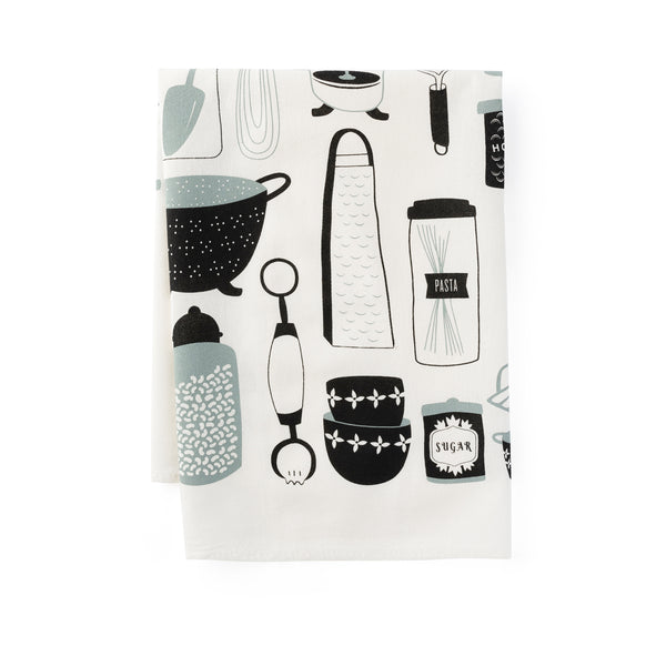 A single 100% cotton flour sack towel with an illustration of kitchen utensils