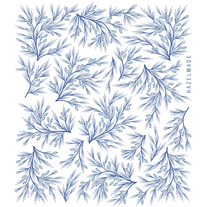 Digital rendering of tea towel with an illustration of blue winter branches