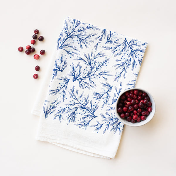 A single 100% cotton flour sack towel with an illustration of blue winter branches