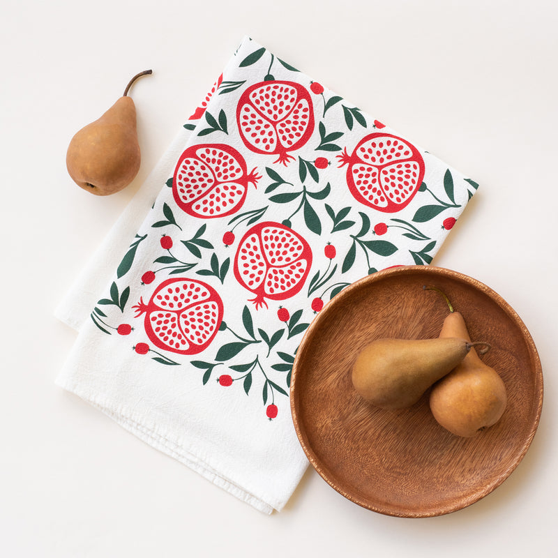 A single 100% cotton flour sack towel with an illustration of pomegranates