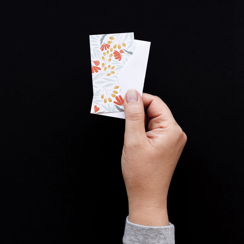 Set of 10 flat mini note cards with envelopes and an illustrated pattern of light blue, red, and gold florals and leaves.