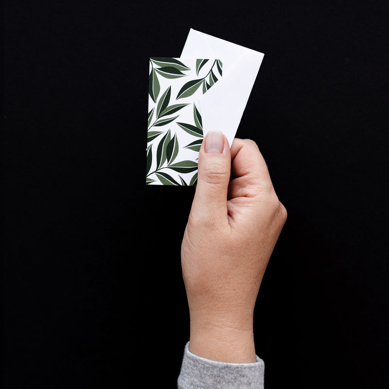 Set of 10 flat mini note cards with envelopes and an illustrated pattern of dark green leaves.