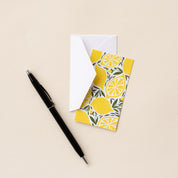 Lemons Mini Note Card with white envelope beside a black pen on a neutral background