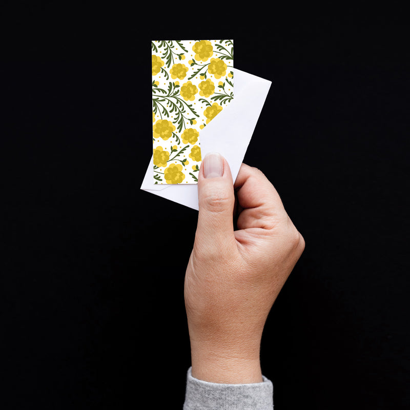 Set of 10 flat mini note cards with envelopes and an illustrated pattern of yellow marigold flowers and dark green vine-like leaves.