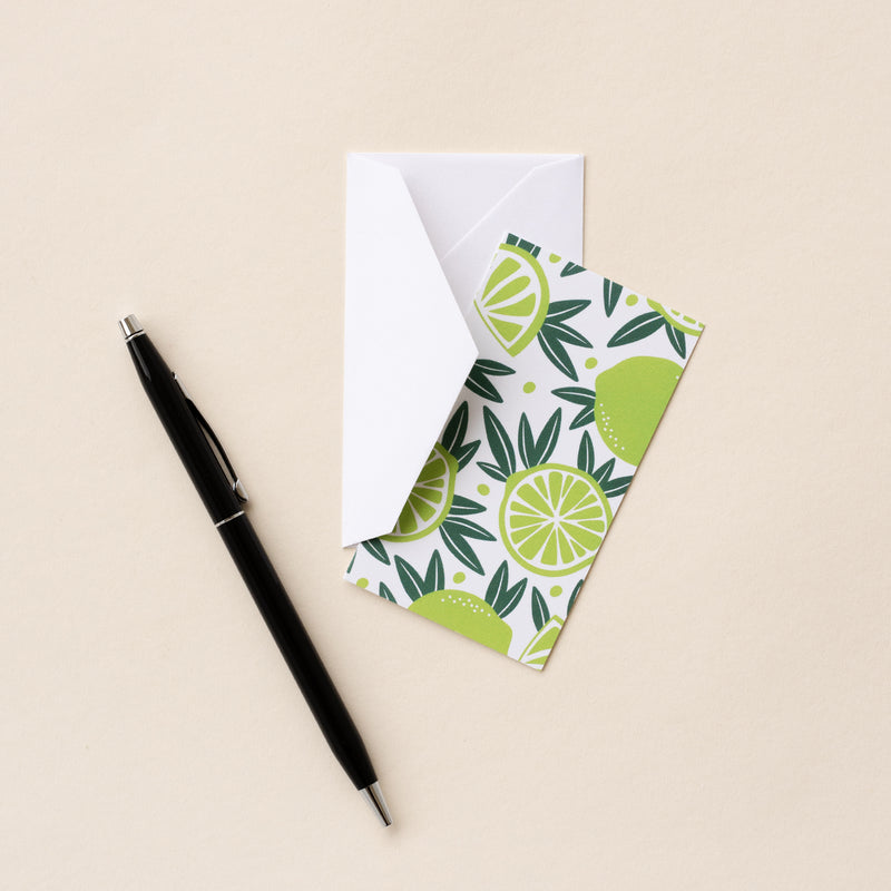 Set of 10 flat mini note cards with envelopes and an illustrated pattern of whole limes and sliced limes in an alternating pattern.