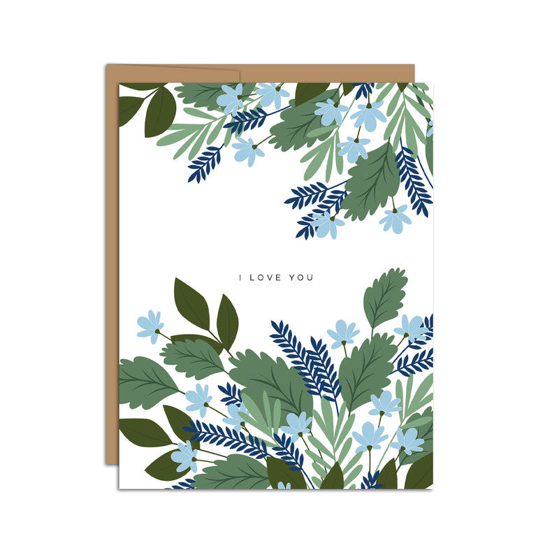 Single folded A2 greeting card with an envelope with an illustration of green leaves and blue flowers wrapping the top and bottom of the card. In the center is blank space with text that states "I Love You".