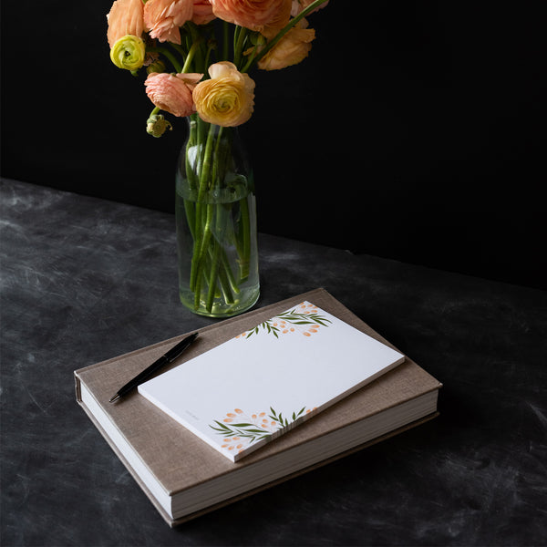 A single 5.5” by 8.5” large notepad with 50 tear-off sheets and an illustration of tuscan florals.