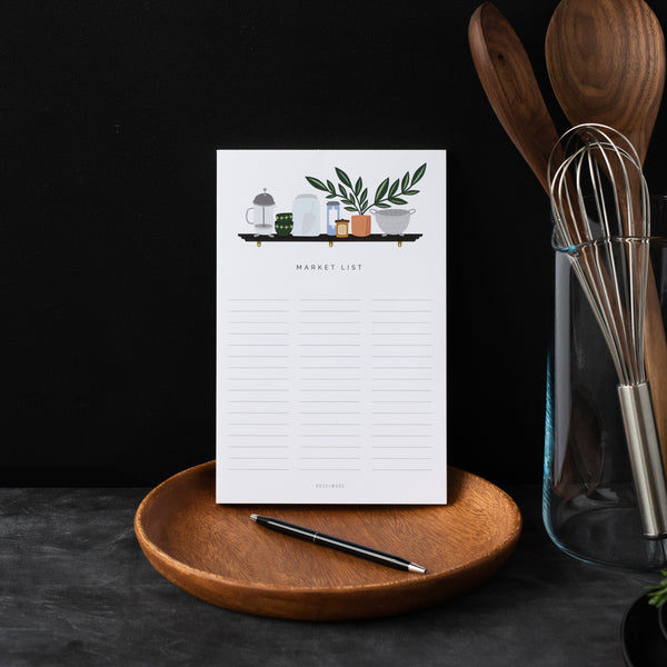 A single 5.5” by 8.5” large notepad with 50 tear-off sheets, an illustration of a shelf with common kitchen items on it, and text that reads "Market List".