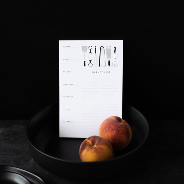 A single 5.5” by 8.5” large notepad with 50 tear-off sheets, an illustration of various kitchen utensils, and text that reads Sunday through Saturday on the left side and "Market List' on the right side.