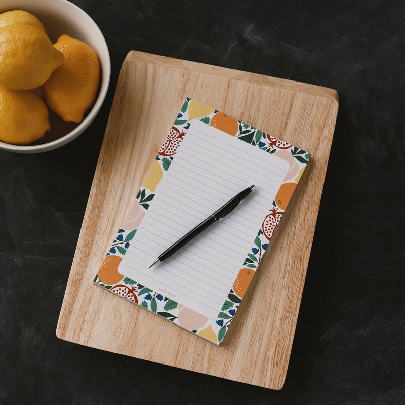 A single 5.5” by 8.5” large notepad with 50 tear-off sheets and an illustration of mixed fruits bordering the notepad.