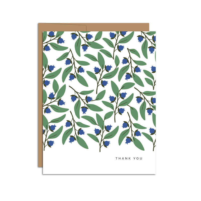 Single folded A2 greeting card with an envelope with an illustration of blueberries and green leaves pattern. In the bottom right is text that states "Thank You".