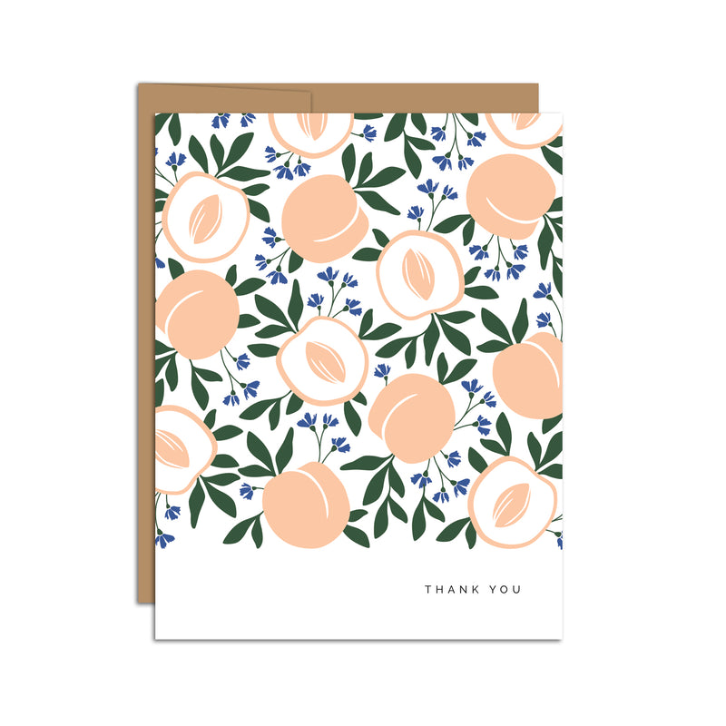 Single folded A2 greeting card with an envelope with an illustration of open peaches with the pit and whole peaches in an alternating pattern. In the bottom right is text that states "Thank You".