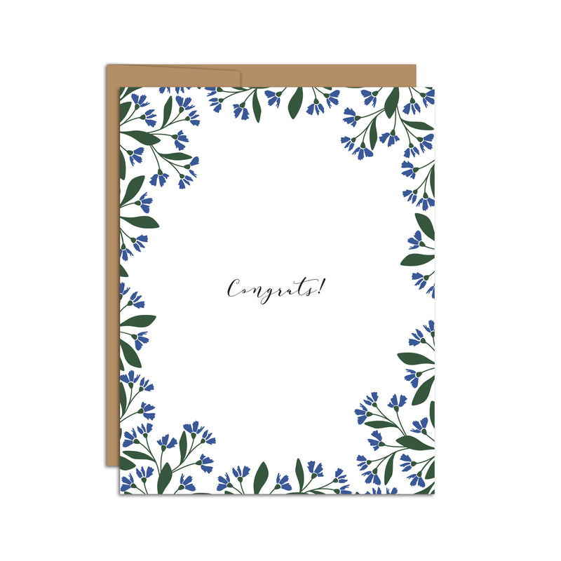 Single folded A2 greeting card with an envelope with an illustration of small blue flowers and green leaves bordering the edge of the card and the center stating "Congrats!".
